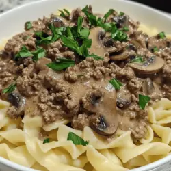 Savory Ground Beef Stroganoff is a classic comfort dish that has warmed the hearts and filled the bellies of families for generations. With its rich flavors and creamy texture, this dish brings a sense of satisfaction that can only come from a home-cooked meal. Imagine tender ground beef simmered with mushrooms and onions in a luscious cream sauce, served over a bed of egg noodles or rice. It's the kind of meal that transforms an ordinary weeknight into something special, making it an ideal choice for busy families and cozy gatherings alike.