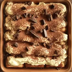 - 2 cups brewed espresso, cooled - 3 tablespoons cocoa powder, plus extra for dusting - 1 cup heavy cream - 1 cup mascarpone cheese - 3/4 cup granulated sugar - 1 teaspoon vanilla extract - 24 ladyfinger biscuits - 1/4 cup milk chocolate shavings (for garnish) - 1/4 teaspoon instant coffee granules (optional)