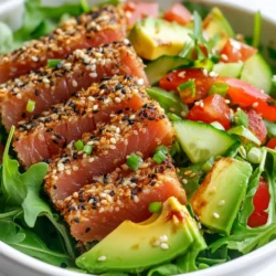 - 2 Ahi tuna steaks (6 oz each) - 1/4 cup black sesame seeds - 1/4 cup white sesame seeds - 1 tablespoon soy sauce - 1 tablespoon sesame oil - 2 cups mixed salad greens (arugula, spinach, and baby kale) - 1/2 cucumber, thinly sliced - 1 red bell pepper, julienned - 1 avocado, sliced - 2 green onions, chopped - 1 tablespoon toasted sesame seeds (for garnish) - Salt and pepper to taste For this salad, I love using fresh Ahi tuna. It has a rich taste and a smooth texture. The sesame seeds add a nice crunch and flavor. I mix black and white seeds for a nice look and taste. Soy sauce and sesame oil add depth to the dish. You can add more flavor and nutrition with extra items. Consider sliced radishes or shredded carrots for some crunch. You can also add nuts like almonds or cashews for a tasty twist. When it comes to dressings, I suggest a simple vinaigrette. A mix of olive oil and lemon juice works well. It keeps the salad light and fresh. If you prefer a creamy dressing, try a tahini dressing. It matches the sesame theme perfectly. {{ingredient_image_1}} First, I pat the Ahi tuna steaks dry with a paper towel. This step helps the seasoning stick better. Next, I lightly season both sides with salt and pepper. This simple step adds great flavor. Then, I prepare a mixture of black and white sesame seeds in a shallow dish. I brush the tuna steaks with soy sauce and sesame oil. This adds a rich flavor. After that, I press each steak into the sesame seeds until they are well-coated. This gives the tuna a nice crunch. I heat a non-stick skillet over medium-high heat. When it's hot, I add a splash of sesame oil. I sear the tuna steaks for about 1-2 minutes on each side. For rare, I cook for 1 minute. For medium-rare, I cook for 2 minutes. When done, I remove the tuna from the heat and let it rest. Resting helps keep the juices inside. In a large bowl, I mix the salad greens, cucumber, red bell pepper, and avocado. I toss them gently to combine. This mix makes the salad fresh and colorful. Next, I slice the seared tuna into thin strips. To assemble, I plate the mixed greens and veggies first. Then, I arrange the sliced tuna on top. Finally, I sprinkle with toasted sesame seeds and garnish with chopped green onions. This adds a nice touch. To find fresh Ahi tuna, look for bright red color. The flesh should be firm and shiny. Avoid any fish that looks dull or brown. A fresh tuna steak should smell like the ocean, not fishy. You can buy high-quality tuna at a local fish market or a reputable grocery store. Ask the fishmonger about the source of the tuna. Wild-caught is often the best choice for flavor and sustainability. To toast sesame seeds, heat a dry skillet over medium heat. Add the seeds and stir them often. They will turn golden brown in about 3 to 5 minutes. Keep a close eye on them to avoid burning. Toasting brings out the nutty flavor of sesame seeds. If they burn, they taste bitter. So, stay near the stove while toasting. Pair the salad with light dressings, like a citrus vinaigrette. This adds a nice zing to the dish. You can also serve it with a creamy dressing for contrast. For a great presentation, arrange the salad on a large plate. Place the greens and veggies first, then add the sliced tuna on top. Finish with a sprinkle of toasted sesame seeds and chopped green onions. This adds color and crunch to your dish. Pro Tips Freshness is Key: Always choose the freshest Ahi tuna available for the best flavor and texture. Look for bright, shiny flesh and avoid any tuna with a dull appearance. Perfect Searing: Ensure your skillet is hot enough before adding the tuna. A proper sear locks in moisture and creates a delicious crust. Customize Your Salad: Feel free to add other vegetables or toppings to your salad, such as cherry tomatoes, radishes, or a sprinkle of chili flakes for extra flavor. Chill Your Tuna: For an even fresher taste, chill your tuna steaks in the refrigerator for 30 minutes before searing. This helps firm up the fish and enhances the overall dish. {{image_2}} You can easily switch Ahi tuna for other proteins. Salmon, chicken, or tofu work great. - Salmon: It has a rich flavor and is high in omega-3s. - Chicken: A lean option that’s also filling. - Tofu: Perfect for a plant-based choice. These alternatives keep the dish tasty while catering to different diets. Try new dressings to change the flavor of your salad. A zesty lemon vinaigrette adds a nice kick. - Fruits: Add mango or citrus for sweetness. - Nuts: Toss in almonds or walnuts for crunch. Experimenting with these ingredients makes your salad exciting and fun. You can modify this salad for various diets. It’s easy to make it gluten-free or vegan. - Gluten-Free: Use tamari instead of soy sauce. - Vegan/Vegetarian: Replace tuna with marinated tofu or chickpeas. These adjustments ensure everyone can enjoy this fresh and flavorful dish. To keep your leftover salad fresh, store it in an airtight container. This helps prevent wilting. The salad stays good for up to two days in the fridge. If you add dressing, it may last only one day. To keep it crisp, store the dressing separately. If you have leftover tuna, you can reheat it gently. Use a skillet over low heat. This method keeps the flavor and texture intact. Avoid microwaving, as it can make the tuna dry. Heat it just until warm, about 1-2 minutes. You can freeze cooked tuna to enjoy later. Wrap it tightly in plastic wrap or foil. Then place it in a freezer bag. This method helps prevent freezer burn. For thawing, move it to the fridge overnight. This keeps the tuna moist and tasty. The best way to cook Ahi tuna is by searing it. This keeps the fish tender and juicy. Here are some tips to get it right: - Pat the tuna dry: Use a paper towel to remove excess moisture. - Season lightly: Add a pinch of salt and pepper before cooking. - Use high heat: A hot skillet helps get a nice crust. - Cook briefly: Sear for 1-2 minutes per side, depending on how rare you like it. - Let it rest: Allow the tuna to rest for a minute after cooking. This keeps it moist. If you don't have sesame oil, you can use other oils. Here are some great options: - Peanut oil: It has a nutty flavor similar to sesame. - Canola oil: A neutral choice that works well in recipes. - Olive oil: Use extra virgin for a richer taste. - Sunflower oil: This has a light flavor and is easy to find. Each oil brings a unique taste, so pick one that fits your dish. Yes, you can prepare parts of this salad ahead of time. Here’s how: - Store tuna separately: Cooked tuna can be kept in the fridge for up to two days. - Prep veggies: Wash and cut your salad greens and veggies a day before. - Avoid dressing: Don’t dress the salad until you’re ready to serve. This keeps it fresh. By following these tips, you can enjoy this refreshing salad even on busy days! This blog post covered everything you need to know about creating a delicious Ahi tuna salad. We discussed key ingredients, from the tuna and veggies to flavor-packed dressings. You learned step-by-step how to prepare and cook the tuna, assemble your salad, and even explore variations. Remember to choose fresh ingredients and follow the best storage tips for leftovers. You can make it your own with different proteins and flavors. Enjoy your salad-making journey!