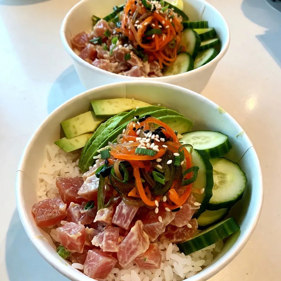 To make these tasty spicy tuna sushi bowls, you need a few key items. Here’s what you’ll need: - 1 cup sushi rice - 1 1/4 cups water - 1 tablespoon rice vinegar - 1 tablespoon sugar - 1/2 teaspoon salt - 8 oz fresh sushi-grade tuna, diced - 2 tablespoons mayonnaise (preferably Japanese Kewpie) - 1 tablespoon sriracha (adjust to taste) - 1 avocado, sliced - 1 cucumber, thinly sliced - 1/4 cup seaweed salad - 2 green onions, thinly sliced - Sesame seeds, for garnish - Soy sauce, for drizzling These ingredients create a delicious base. You can find sushi-grade tuna at specialty fish markets or select grocery stores. Feel free to add more fun items to your bowls. Here are some ideas: - Pickled ginger for a zesty kick - Wasabi for some heat - Extra seaweed salad for crunch - Radish sprouts for freshness These additions can enhance flavor and texture. You can mix and match to suit your taste. Many ingredients pop up in sushi recipes. Here are some common ones you might use: - Nori sheets for wrapping sushi - Soy sauce for dipping - Rice vinegar for seasoning rice - Mirin for sweetness These items help you create various sushi dishes. Stocking your pantry with these essentials makes cooking easier and more fun. {{ingredient_image_1}} To start, rinse 1 cup of sushi rice under cold water. Do this until the water runs clear. Next, combine the rice and 1 1/4 cups of water in a rice cooker. If you don’t have one, bring the rice and water to a boil in a saucepan. Cover it, then lower the heat. Cook for 16-18 minutes, or until the water is gone. After cooking, remove it from the heat and let it sit covered for 10 minutes. This step helps the rice become fluffy and sticky. In a separate bowl, you will mix the spicy tuna filling. Take 8 oz of fresh sushi-grade tuna and dice it into small pieces. Add 2 tablespoons of mayonnaise, preferably Japanese Kewpie, to the bowl. Then, add 1 tablespoon of sriracha. Mix well until the tuna is fully coated. You can adjust the spiciness by adding more sriracha if you want. This mixture is key for a punchy flavor in your bowl. Now, it’s time to assemble your sushi bowls. Start with a base of sushi rice at the bottom of each bowl. Scoop a generous amount of the spicy tuna mixture on top. Next, add sliced avocado, cucumber, and a little seaweed salad. For garnish, sprinkle sesame seeds and thinly sliced green onions on top. Finally, drizzle some soy sauce over the entire bowl for added flavor. Your spicy tuna sushi bowl is now ready to enjoy! When selecting sushi-grade tuna, freshness is key. Look for bright red or deep pink color. It should have a firm texture and smell like the ocean, not fishy. Buy from a trusted fish market or grocery store. Ask if they carry sushi-grade fish. If you can, check for certification labels. This ensures the fish meets safety standards for raw consumption. To make great sushi rice, start by rinsing the rice well. This removes excess starch and prevents stickiness. Use a rice cooker for the best results, but a saucepan works too. Once cooked, let it rest for ten minutes off the heat. Mix rice vinegar, sugar, and salt until dissolved. Gently fold this mixture into the rice. This adds flavor and gives the rice a nice shine. Presentation elevates your sushi bowl. Start with a base of warm, seasoned sushi rice. Then layer on the spicy tuna mix. Add sliced avocado and cucumber for color and crunch. Top with seaweed salad and sprinkle sesame seeds on top. For a fun touch, serve with chopsticks and a small dish of soy sauce. A bamboo mat can add an authentic feel to your table. Pro Tips Rinse the Rice: Always rinse sushi rice thoroughly to remove excess starch. This helps achieve the perfect sticky texture for your sushi bowls. Quality Tuna: Use the freshest sushi-grade tuna available. It makes a significant difference in flavor and texture, ensuring a delicious dish. Customize Spice Levels: Feel free to adjust the amount of sriracha to match your heat preference. Start with less and add more gradually to find your perfect balance. Garnish with Purpose: Add garnishes like sesame seeds and green onions not only for flavor but also to enhance the visual appeal of your sushi bowls. {{image_2}} You can swap tuna for other proteins. Salmon works well and adds rich flavor. Crab meat is another tasty choice. For a unique twist, try shrimp or even cooked chicken. Each protein brings its own taste and texture. Just ensure you use fresh, high-quality ingredients. You don’t need fish for a great bowl. Try marinated tofu as a protein. It soaks up flavors well and adds a nice texture. You can also use chickpeas for a hearty alternative. Another option is to use mushrooms. Shiitake or portobello mushrooms give a savory taste. Pair these with your favorite veggies for a filling meal. Customization makes each bowl unique. Add extra toppings like pickled ginger or radishes. You can include sliced carrots or mango for sweetness. For crunch, try adding nuts or crispy onions. Drizzle with different sauces like teriyaki or ponzu for a new flavor. Get creative and make it your own! To store leftover sushi bowls, first, let them cool to room temperature. Place the rice and toppings in separate airtight containers. This keeps the rice from getting soggy. You can store them in the fridge for up to two days. For best taste, eat them within this time. If you need to reheat sushi rice, avoid using the microwave. Instead, steam the rice in a pot with a little water. This method helps keep the rice’s texture. Heat it just until warm, not hot. Stir gently to avoid breaking the grains. To keep ingredients fresh, store them properly. Keep tuna in the coldest part of your fridge. Use it within one day for the best quality. Store sliced avocado in an airtight container with a squeeze of lemon juice. This prevents browning. For cucumbers and seaweed salad, wrap tightly in plastic wrap to maintain freshness. If you can't find sushi rice, you can use short-grain rice or even jasmine rice. Both types of rice will give you a nice texture. Just remember to rinse it until the water runs clear. This step helps remove excess starch. You want sticky rice for your sushi bowls. Yes, raw tuna can be safe if it is sushi-grade. Always buy fresh fish from a trusted source. Look for fish marked as sushi-grade or sashimi-grade. This means it is safe to eat raw. If you're unsure, ask your fishmonger for advice. To tone down the heat, reduce the sriracha in your spicy tuna mix. You can also add more mayonnaise to balance the flavors. Another option is to include diced cucumber or avocado in your mix. These ingredients add creaminess and freshness, which helps with the spice level. Spicy tuna sushi bowls combine fresh ingredients with simple steps for a tasty meal. We covered the key ingredients and how to prepare sushi rice and spicy tuna filling. With tips for choosing tuna and serving, you can impress anyone. Explore variations for different diets and learn to store leftovers properly. This guide helps you create delicious sushi bowls at home, tailored to your taste. Enjoy experimenting with flavors and techniques as you become confident in making these bowls your own. Happy cooking!
