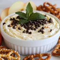 - 8 oz cream cheese, softened - 1/2 cup powdered sugar - 1/2 cup sour cream - 1 teaspoon peppermint extract - 1/2 cup mini chocolate chips - 1/4 cup crushed peppermint candies - 1/2 teaspoon vanilla extract These main ingredients create a rich, creamy base for the dip. The cream cheese gives it a smooth texture. The sour cream adds a tangy kick. The powdered sugar sweetens, while the peppermint extract brings a fresh flavor. Mini chocolate chips add sweetness and texture. Crushed peppermint candies give it a fun crunch. - Fresh mint leaves for garnish - Additional crushed peppermint candies Garnishes make your dip look lovely. Fresh mint leaves add color and a pop of flavor. More crushed peppermint candies can boost the festive feel. - Assorted dippers (e.g., graham crackers, apple slices, pretzels) Choosing the right dippers is key. Graham crackers are sweet and crunchy. Apple slices bring a crisp, fresh taste. Pretzels offer a salty contrast that pairs well with the sweet dip. You can mix and match! {{ingredient_image_1}} 1. Start with 8 oz of softened cream cheese. Place it in a large mixing bowl. 2. Beat the cream cheese with an electric mixer. Mix until it is smooth and creamy. This step is key for a silky texture. 3. Gradually add 1/2 cup of powdered sugar. Mix well until fluffy and fully combined. This gives sweetness to the dip. 1. Next, add 1/2 cup of sour cream to the bowl. This adds creaminess and tang. 2. Include 1 teaspoon of peppermint extract and 1/2 teaspoon of vanilla extract. These flavors make it festive and refreshing. 3. Once combined, gently fold in 1/2 cup of mini chocolate chips and 1/4 cup of crushed peppermint candies. Use a spatula to ensure even distribution without breaking the chips. 1. Transfer the cheesecake dip to a serving bowl. Cover it and chill in the fridge for at least 30 minutes. Chilling helps the flavors blend well. 2. When ready to serve, garnish with fresh mint leaves and a sprinkle of extra crushed peppermint candies. This adds a nice touch. 3. Serve with assorted dippers like graham crackers, apple slices, or pretzels. These provide a fun contrast to the creamy dip. Enjoy the delightful mix of flavors! To get the best dip, start with room temperature cream cheese. Cold cream cheese won't mix well. You want a smooth and creamy base. If you beat it while cold, you may get lumps. Mix until it’s fluffy and free of bumps. Adjust the sweetness to your taste. If you prefer it less sweet, add less powdered sugar. You can also try different extracts. Almond or vanilla can give a nice twist. Experiment until you find your favorite flavor. Prepare your dippers ahead of time. This way, you can serve right away. Grahams, apple slices, and pretzels work great. For a fun look, arrange them on a colorful platter. Add a few mint leaves for a pop of color and freshness. Pro Tips Use Room Temperature Cream Cheese: Ensuring your cream cheese is softened to room temperature will help achieve a smoother texture and prevent lumps in your dip. Adjust Peppermint Flavor: Depending on your preference, you can adjust the amount of peppermint extract. Start with a smaller amount and taste as you go to find your perfect balance. Chill for Best Flavor: Allowing the dip to chill for at least 30 minutes helps the flavors meld together, resulting in a more delicious and cohesive taste. Creative Dipper Options: Experiment with a variety of dippers like chocolate cookies, pretzel crisps, or even fruit like strawberries for a delightful contrast to the creamy dip. {{image_2}} You can change the taste of this dip by adding different extracts. Try vanilla or almond for a unique twist. These flavors blend well with the peppermint and chocolate. You can also use dark or milk chocolate chips. Each type brings a new flavor profile to the dip. For those with gluten issues, you can use gluten-free dippers. Look for gluten-free graham crackers or fresh fruit. If you are on a sugar-free or low-calorie diet, you can substitute powdered sugar. Use a sugar alternative that measures the same. This way, you can still enjoy this tasty dip without guilt. Make your dip festive by adding colorful toppings. Use red and green crushed peppermint for a holiday look. You can also pair the dip with seasonal treats. Think sugar cookies or gingerbread. These combinations will bring joy to any gathering. To keep your peppermint chocolate chip cheesecake dip fresh, store it in an airtight container. This helps prevent any odors from other foods from seeping in. Place the container in the fridge right after serving. Your dip will stay good for about 3 to 5 days. Always check for any signs of spoilage before eating. Yes, you can freeze cheesecake dip! Freezing can work well if you want to save some for later. To freeze, first, place the dip in a freezer-safe container. Make sure to leave some space at the top, as the dip may expand. When you want to eat it, move the dip to the fridge to thaw for about 8 hours. After thawing, stir it well to regain its creamy texture. You can use leftover dip in fun ways! Try spreading it on toast or using it as a topping for pancakes. You could also mix it into yogurt for a sweet treat. If the dip is a bit old, think about making mini cheesecakes by layering it with crushed cookies in small cups. These ideas add variety and help reduce waste! To make your cheesecake dip fluffier, start with room temperature cream cheese. This helps it blend smoothly. Use an electric mixer and beat it well for a few minutes. As you add powdered sugar, mix slowly at first. Once combined, increase the speed. This adds air and creates a light texture. You can also add a bit more sour cream for extra fluff. Yes, you can substitute some ingredients. If you don’t have cream cheese, use Greek yogurt. It gives a nice tang and similar texture. For a lower sugar option, try a sugar substitute like stevia. Just remember to check the sweetness level, as some are stronger than sugar. This dip is great for many occasions. It fits well at holiday parties, birthdays, and family gatherings. Serve it during game nights or casual get-togethers. The festive flavors make it a hit for Christmas or winter celebrations. Pair it with dippers like graham crackers or apple slices for fun. Yes, you can make this dip ahead of time. Prepare it a day before your event and store it in the fridge. This helps the flavors blend nicely. Just give it a quick stir before serving. If you want, garnish it just before you serve to keep it fresh. This blog post guides you through making a delicious cheesecake dip. You learned about the main ingredients, optional garnishes, and dipper suggestions. I shared step-by-step instructions for preparing, mixing, and serving. You also discovered helpful tips and variations to suit different tastes and dietary needs. Remember, perfecting the dip's consistency and flavors is key. With proper storage, you can enjoy leftovers too. Enjoy creating this tasty treat for your next gathering!